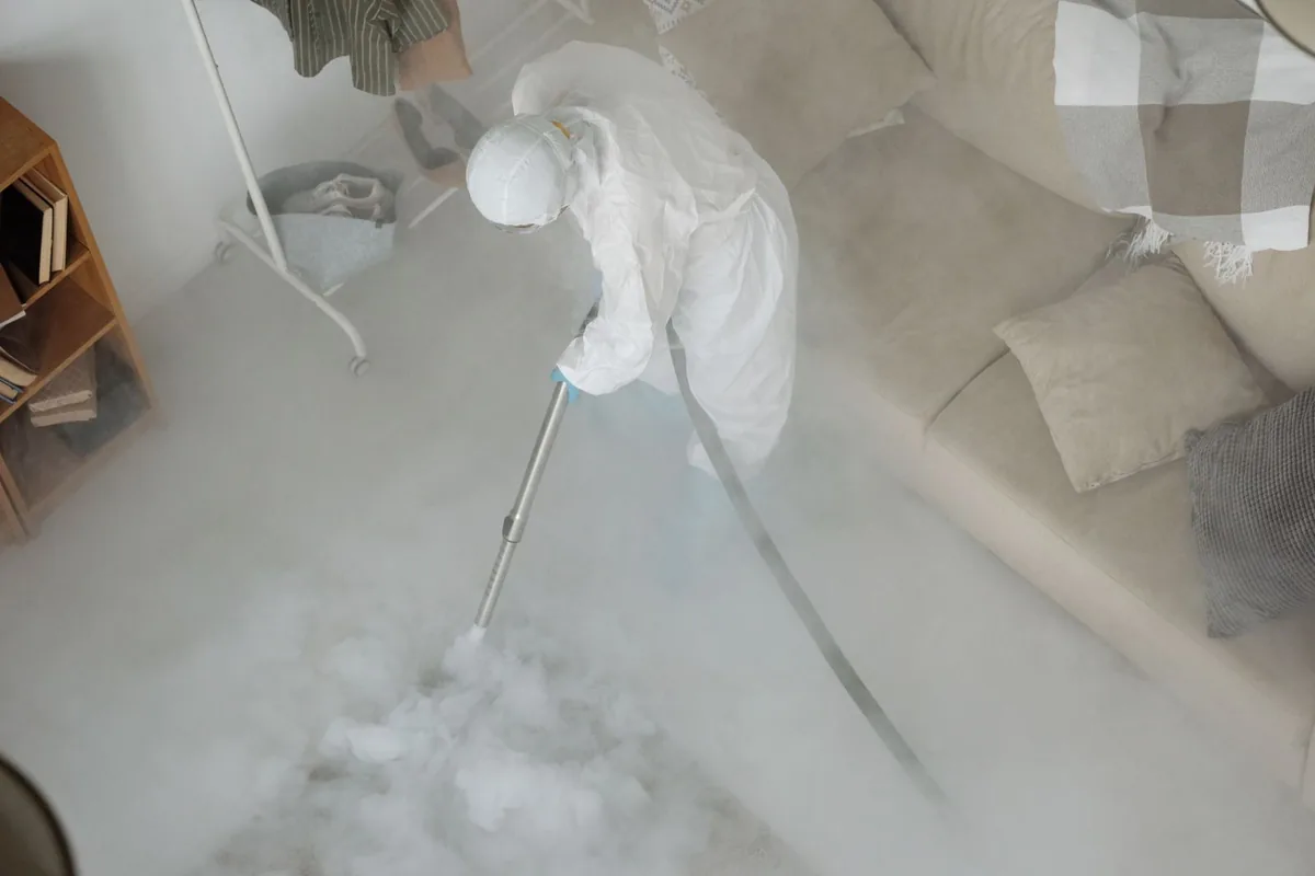 Biohazard cleanup technician in protective equipment, Devine, TX
